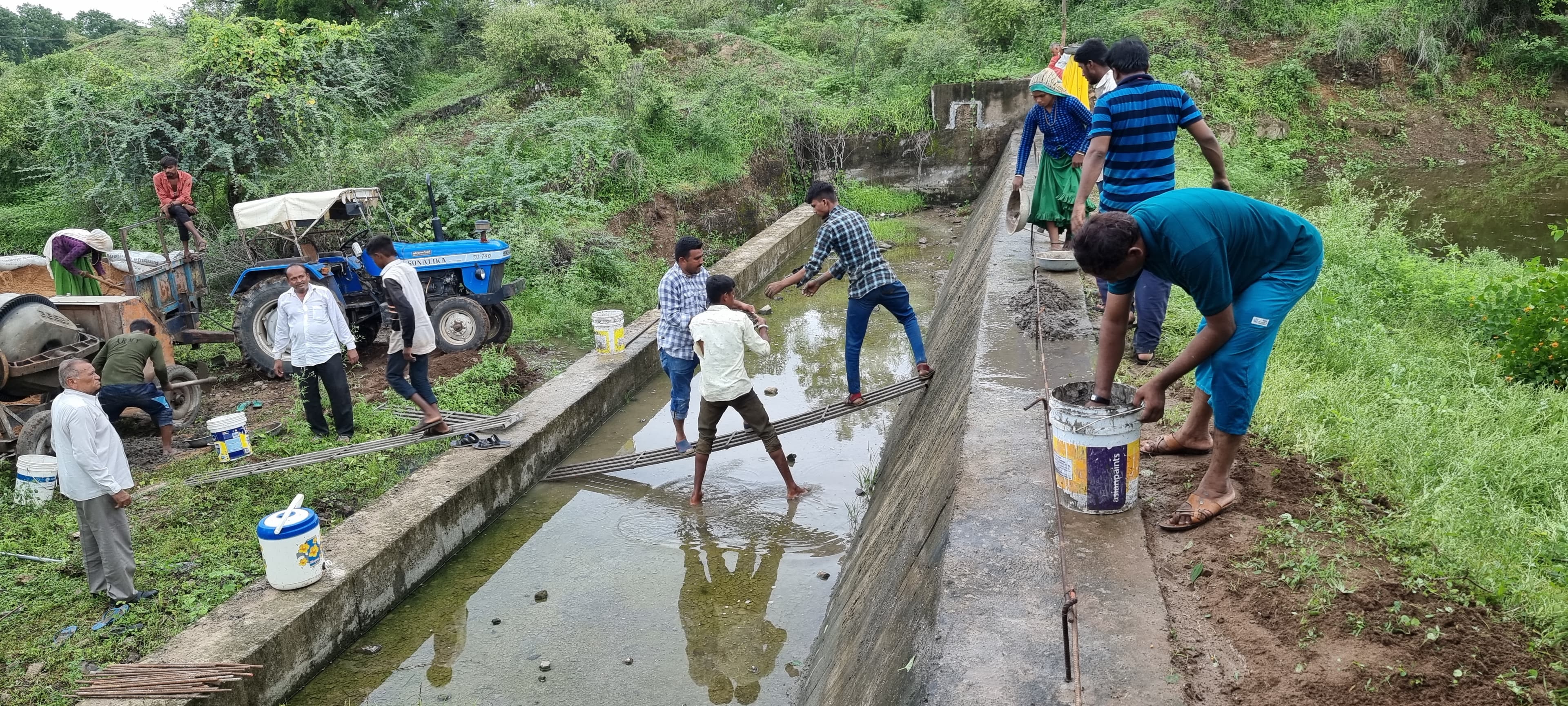 Community members restoring a rural water conservation structure