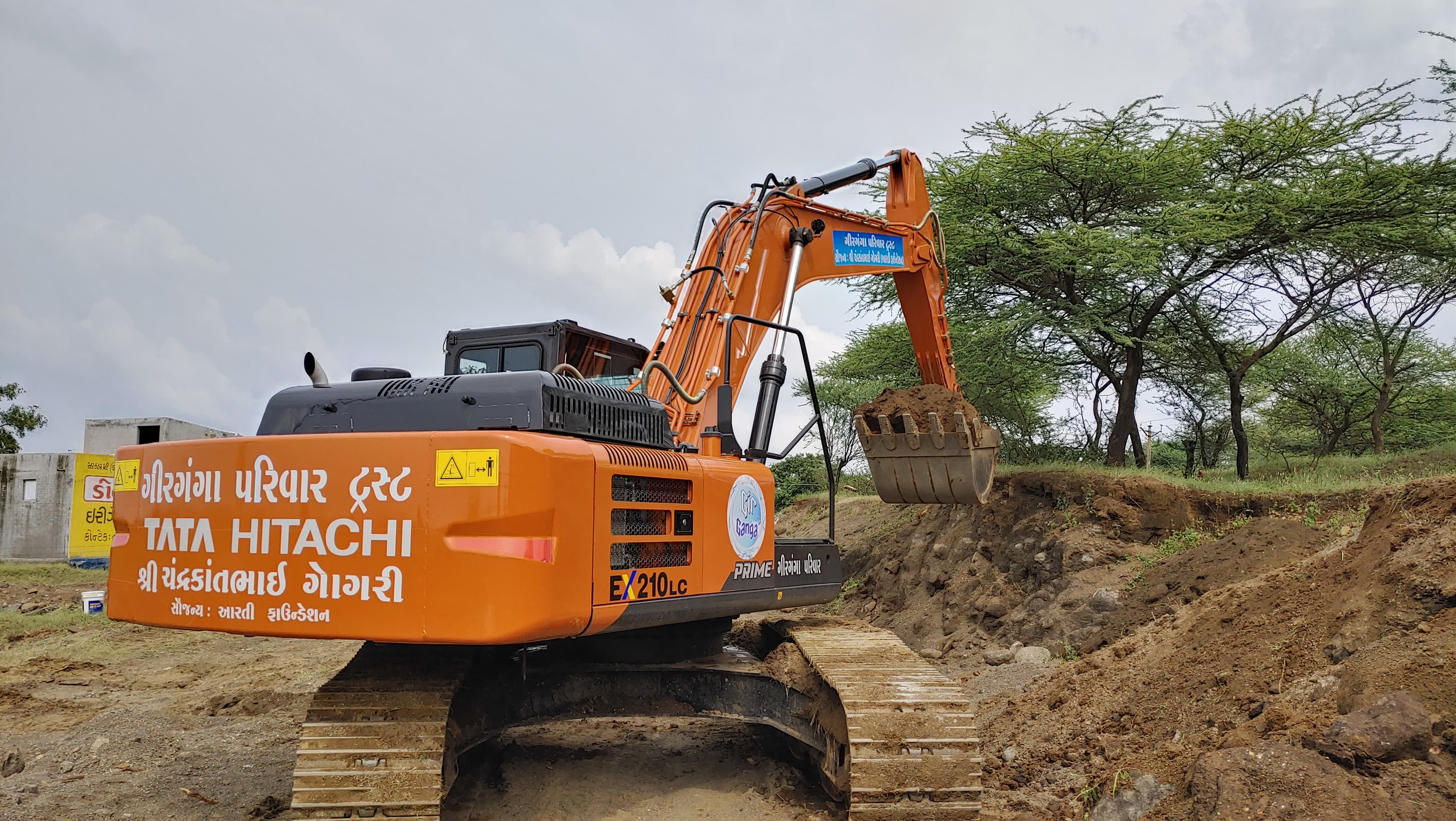 Girganga Parivar Trust excavator carrying out water conservation work